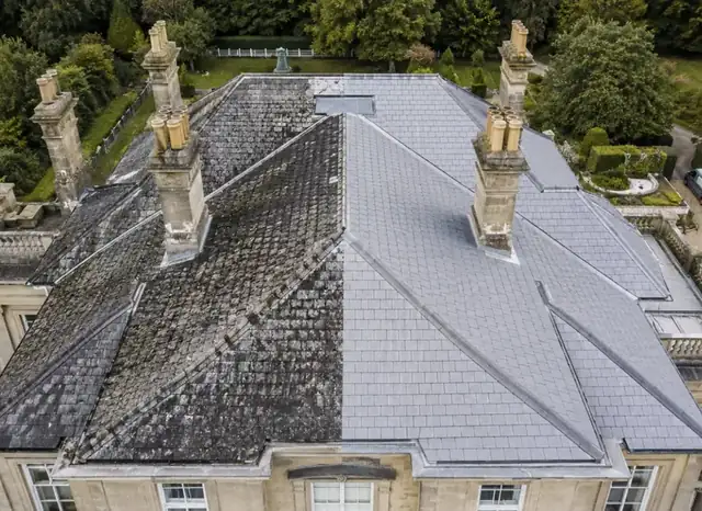 Aerial view of a large period house roof, half cleaned by Arcline