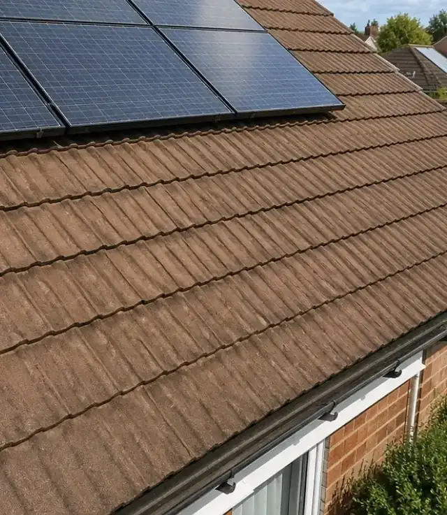 Clean roof tiles around solar panels after a roof clean