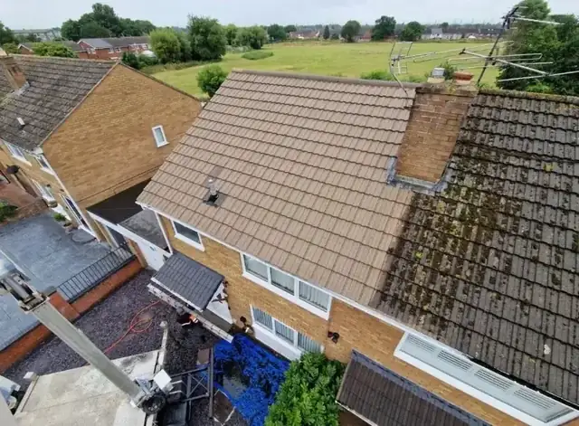 Aerial view of a house roof half cleaned by Arcline